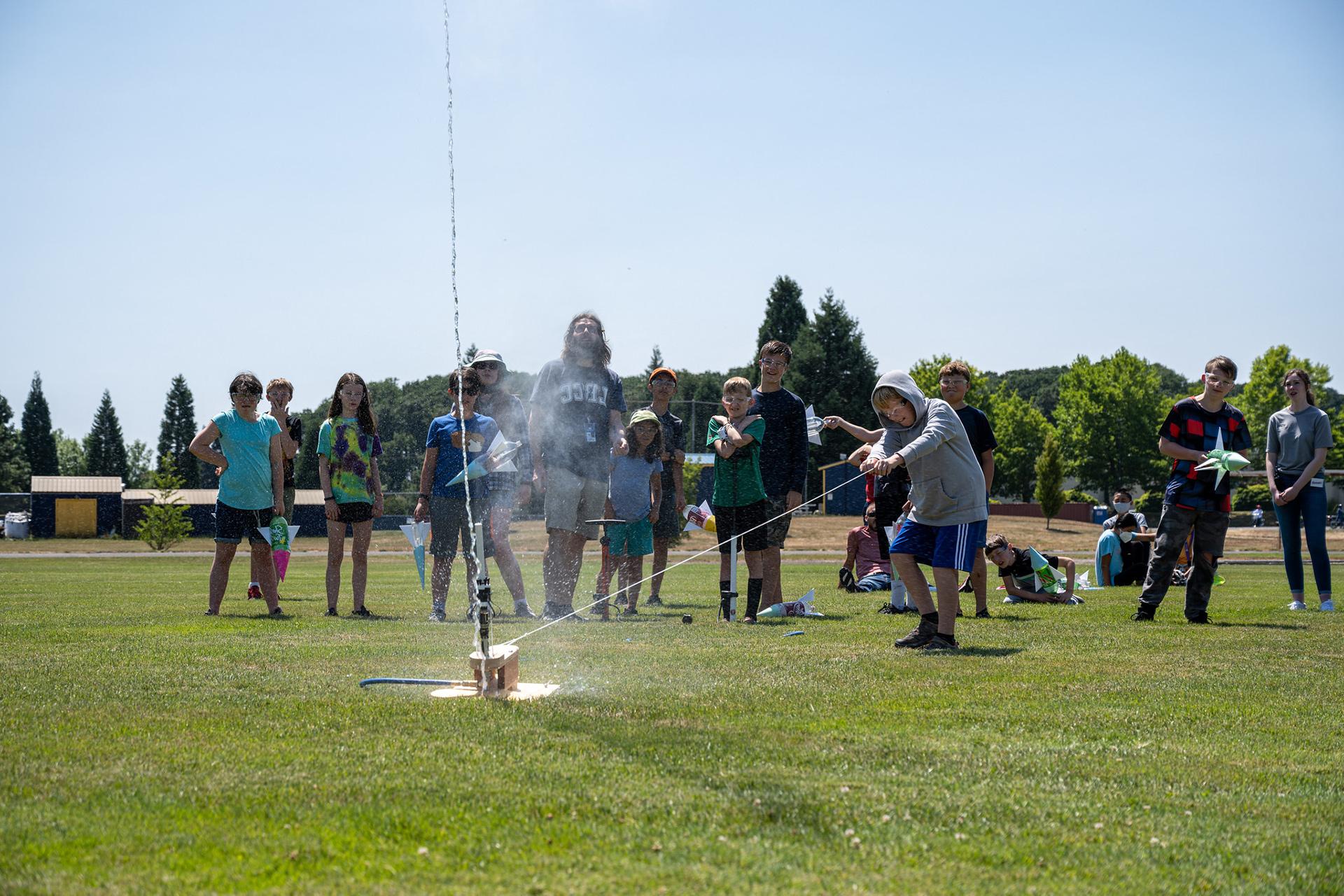 博天堂官方夏令营的学生们向空中发射了一枚手工制作的水力火箭
